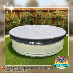 Stock Tank Pool with 'Tipsy Tanks' soft cover on grass with wooden fence background in Pasadena, California