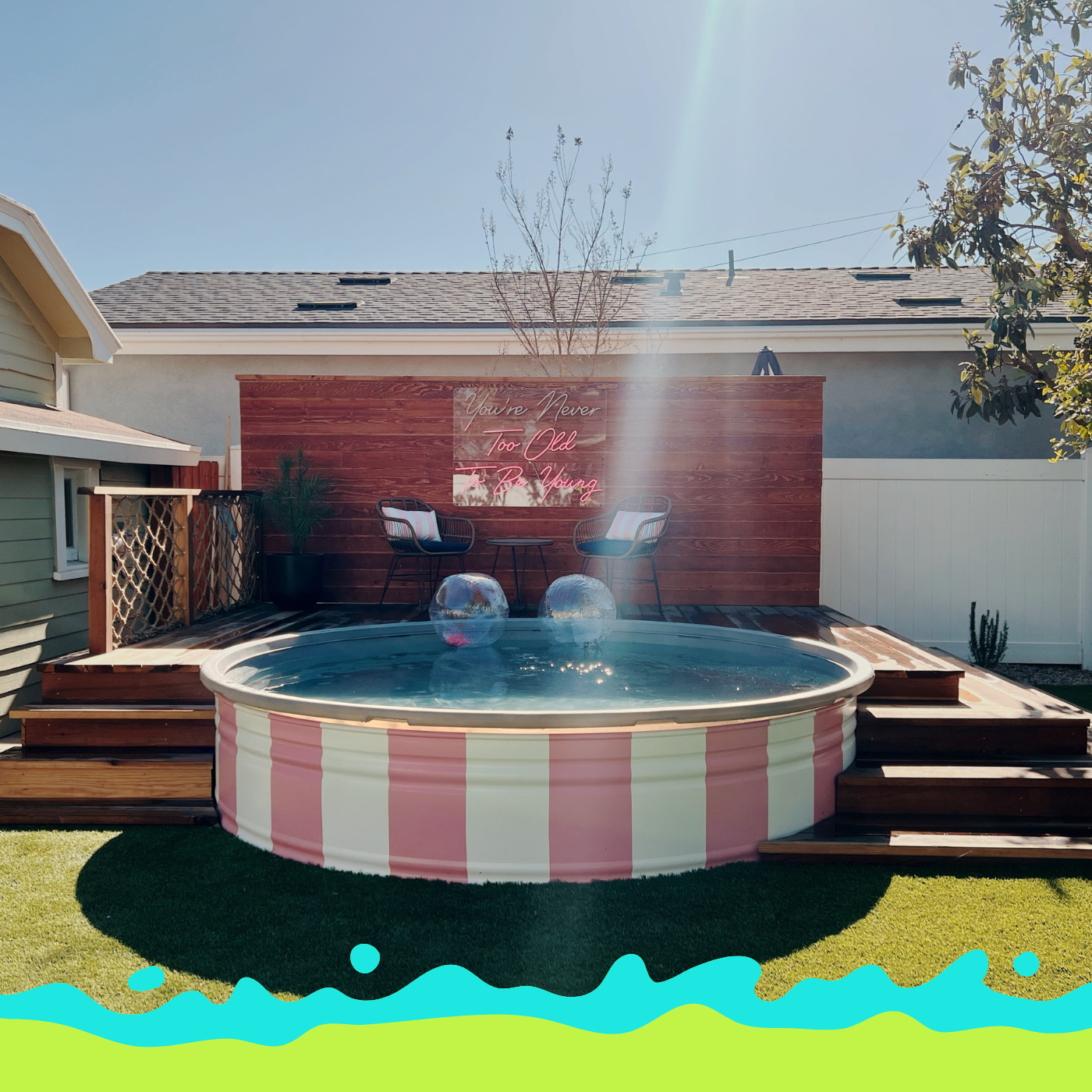 Custom pink-striped 10foot stock tank pool with liner by Tipsy Tank Pools with a raised wood deck in a Santa Ana, California backyard